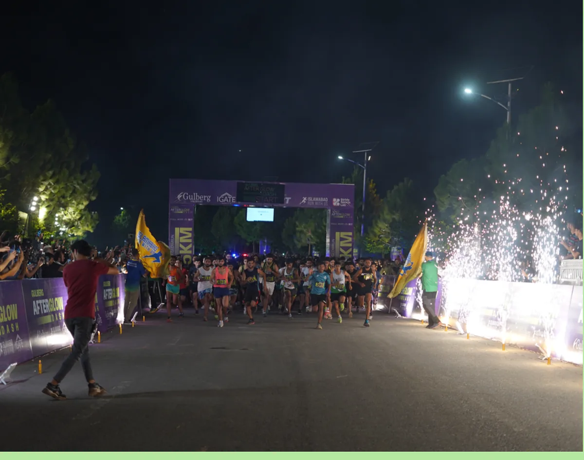 Runners crossing the line as confetti cannons fire