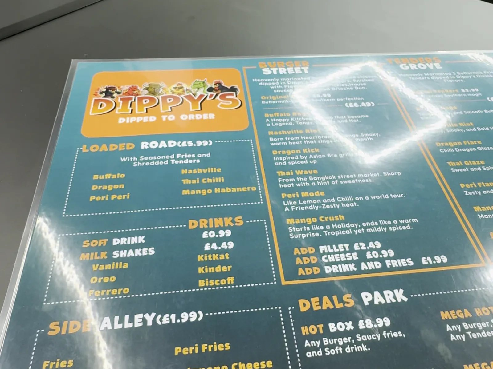 The printed menu on the counter, showing the same sections as the wall boards