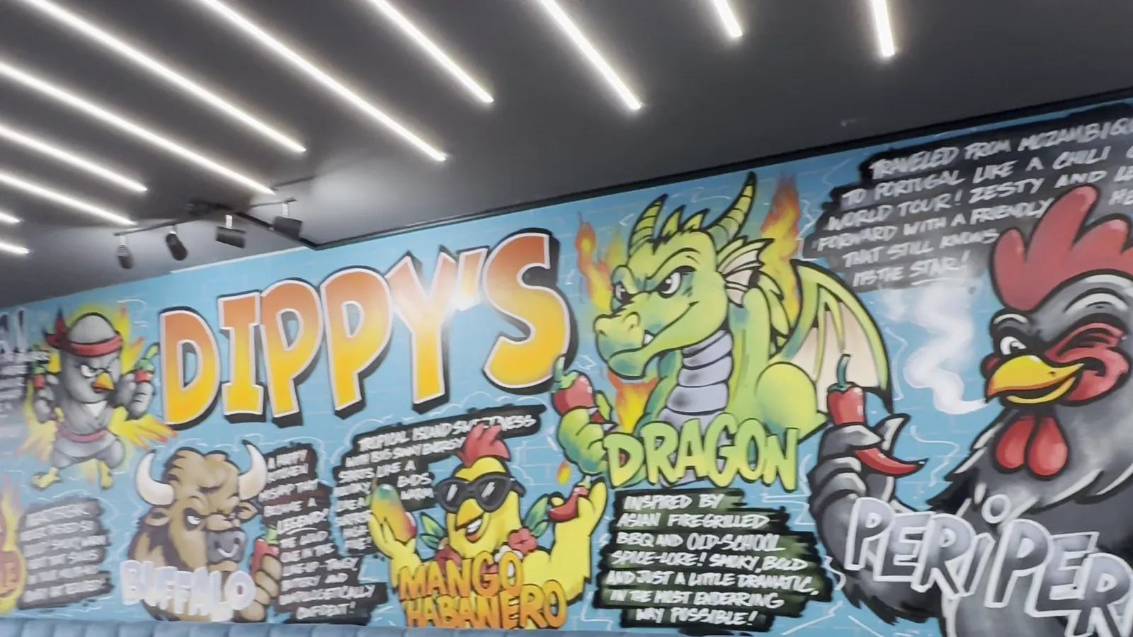 The other end of the painted wall, with the Dragon and Peri Peri characters beside the Dippy's wordmark